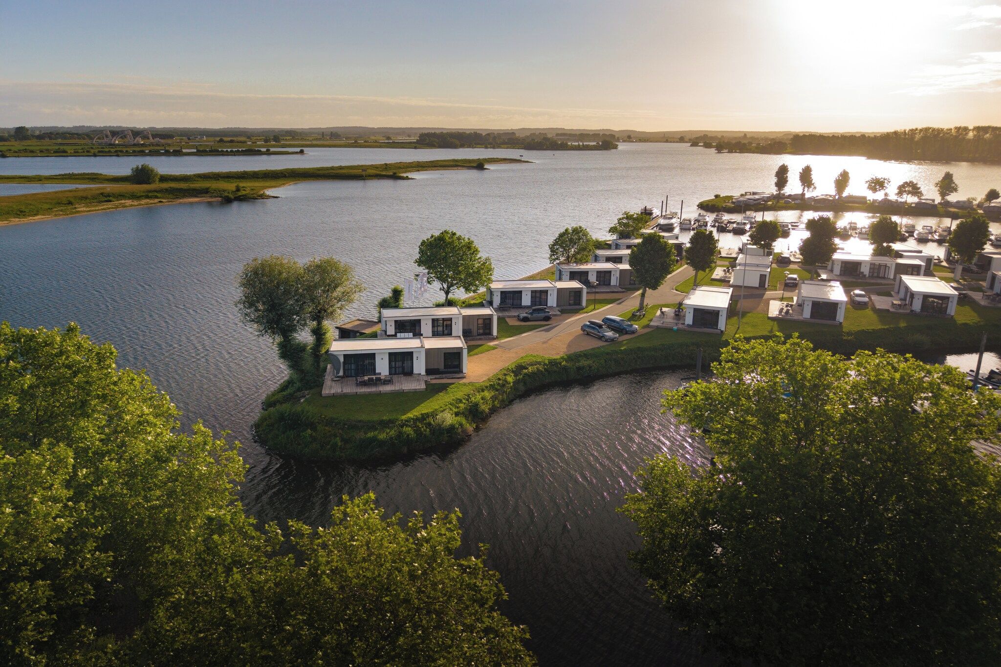 A lakeside property with modern cabins, a marina, and a boat dock.