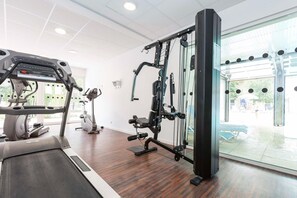 A gym with cardio equipment, a weight machine, and a view of the outside. - Maisonette by Hourtin-Carcans Lake (Hourtin)