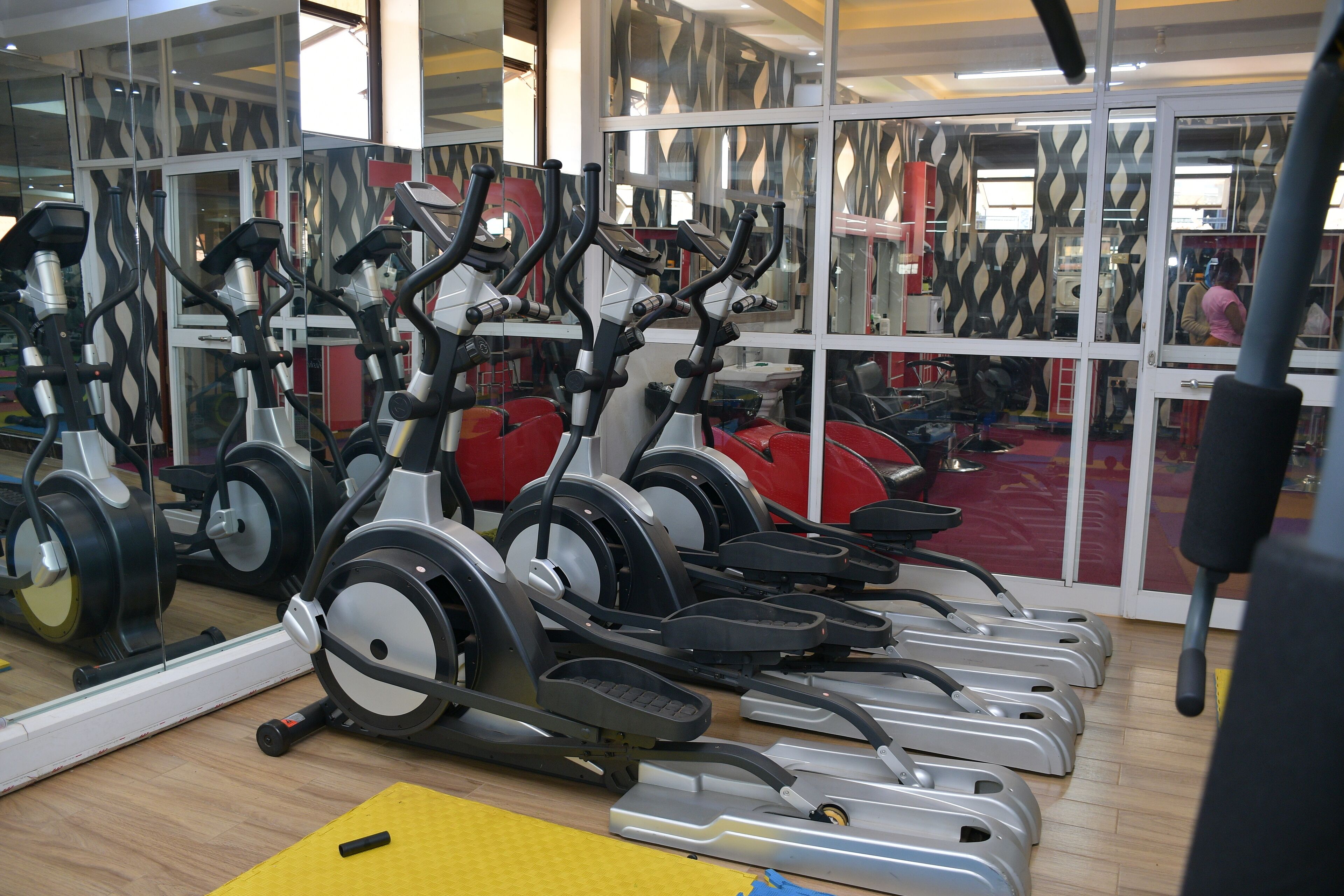 A gym with multiple stationary bikes and exercise equipment.
