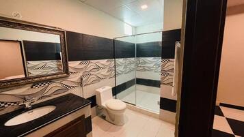 Shower, designer toiletries, slippers, towels