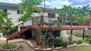 A residential property with a wooden deck, a staircase leading to a covered patio, and a variety of plants. - Wooli Waves - Right on the ocean dune. (Wooli)