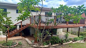 A residential property with a wooden deck, a staircase leading to a covered patio, and a variety of plants. - Wooli Waves - Right on the ocean dune. (Wooli)