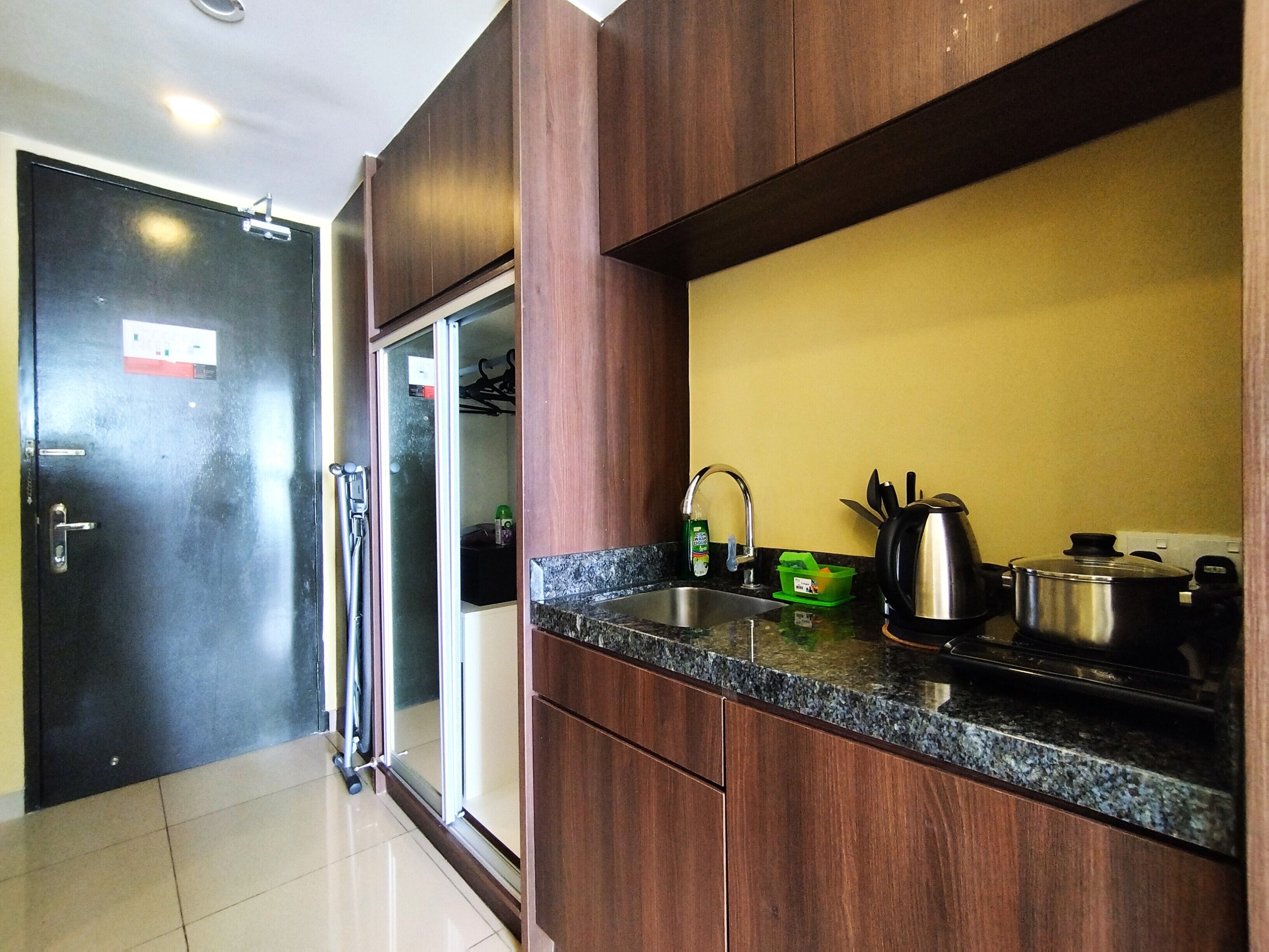 A modern kitchen with granite countertops, stainless steel appliances, and wooden cabinets.