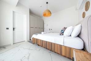 A modern bedroom with a bed, a hanging light fixture, and a white door. - Green Hills Family-Friendly Luxury Villa - Fethiye (Fethiye)