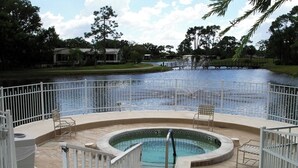 A circular hot tub with a metal railing, surrounded by a white fence. - Golfers getaway with sunny beaches too  (North Fort Myers)