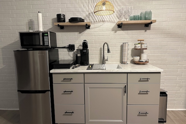 Fridge, microwave, coffee/tea maker, cookware/dishes/utensils