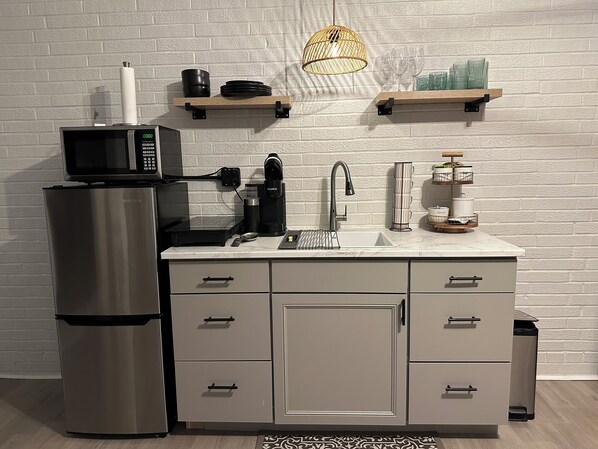 Fridge, microwave, coffee/tea maker, cookware/dishes/utensils