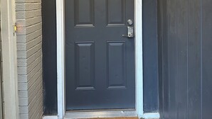 A dark grey door with a keypad lock and a doormat with text. - Modern And Spacious Studio Retreat (Raleigh)