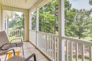 A covered porch with a view of a wooded area. - Golf Getaway w/ Pool Access in Myrtle Beach! (Myrtle Beach)