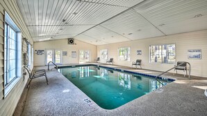 An indoor swimming pool with clear water, a lifeguard station, and signs indicating shallow water is allowed. - Golf Getaway w/ Pool Access in Myrtle Beach! (Myrtle Beach)