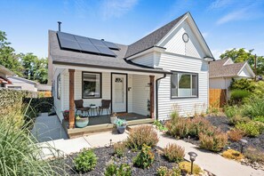 Enjoy a peaceful retreat in this contemporary home surrounded by a well-maintained garden and a covered porch with outdoor seating.