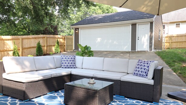 A covered patio area with a sectional sofa and a glass-top coffee table. - Minutes to Keeneland/Airport/UK & more! (Lexington)