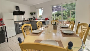 A modern kitchen with a dining area.
