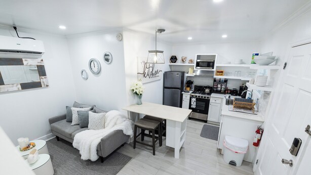 A compact kitchen with a dining area, a built-in oven, and a refrigerator. - Oasis on Poitier in Nassau Bahamas - your private retreat. (Nassau)