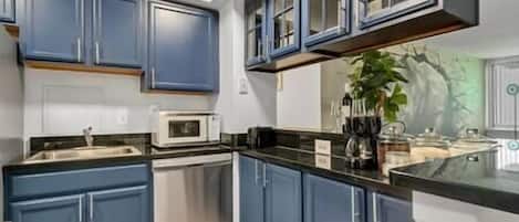 Fridge, microwave, coffee/tea maker, cookware/dishes/utensils