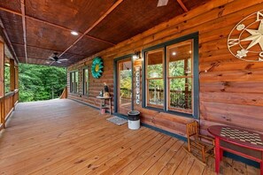 A wooden cabin with a wooden deck, a welcome sign, a compass wall decoration, and a chess table. - Unique Cabin! Close to Blue Ridge GA and Murphy NC. Hot tub has an amazing view. (Mineral Bluff)