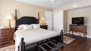 A bedroom with a bed, nightstands, a TV, and a ceiling fan. - Your Home in Monterey, CA (Monterey)