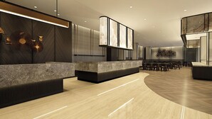 Een moderne hotel lobby met een gebogen receptiebalie, een zithoek en een eetruimte.