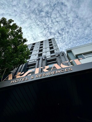 A hotel sign with the name "TRAC HOTEL & RESIDENCES".