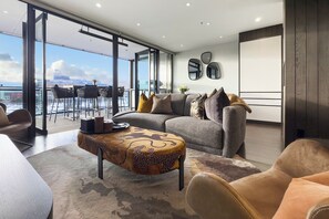 Relax in style with a comfortable sofa, stylish coffee table, and leather armchairs in this serene living space.