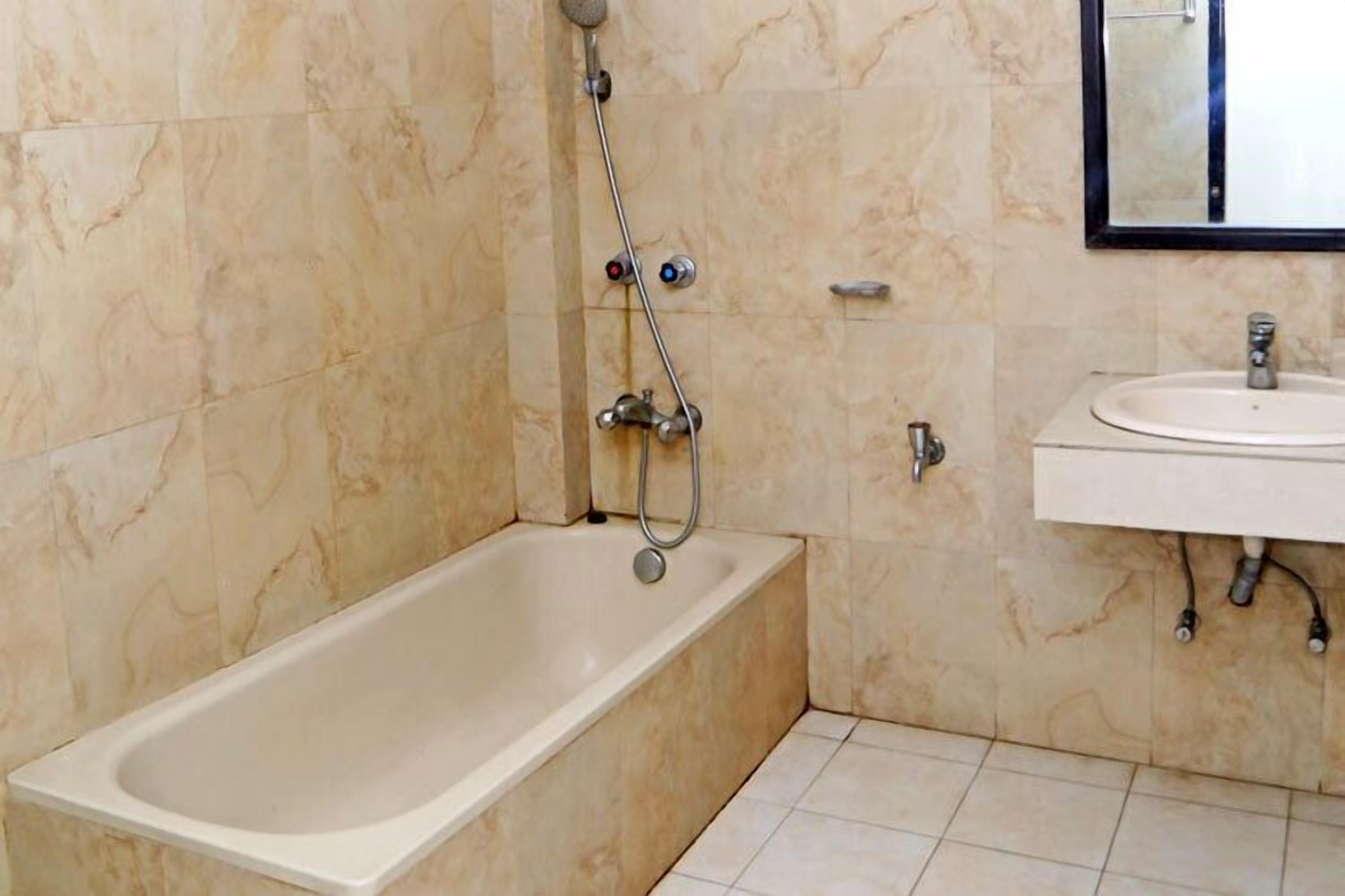 A bathroom with a bathtub, a sink, and a shower.