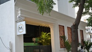 A building with a sign reading "JVL" and a green gate. - JVL By Nexottel (Rajkot)