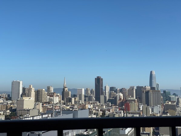 A city skyline with various high-rise buildings, including a distinctive spire and a modern curved skyscraper.
