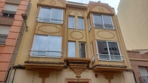 A multi-story building with balconies, large windows, and decorative architectural elements. -  Bieti Castellon (Castelló de la Plana)
