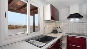 A modern kitchen with a built-in sink, a window, and a view of the outdoors. - Luxury Ocean View holiday home with sea view and shared pool (Corralejo)
