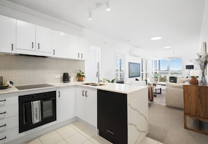 Enjoy a spacious kitchen and living area with an oven, dishwasher, and large island.