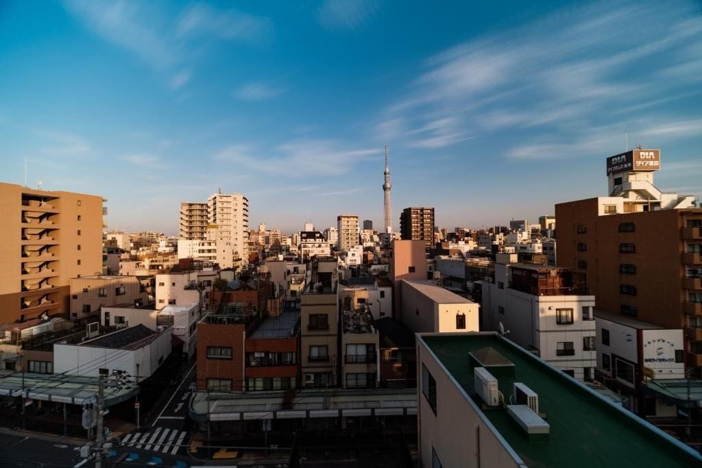 A densely packed urban area with various buildings, including a prominent tower and a building with a sign.