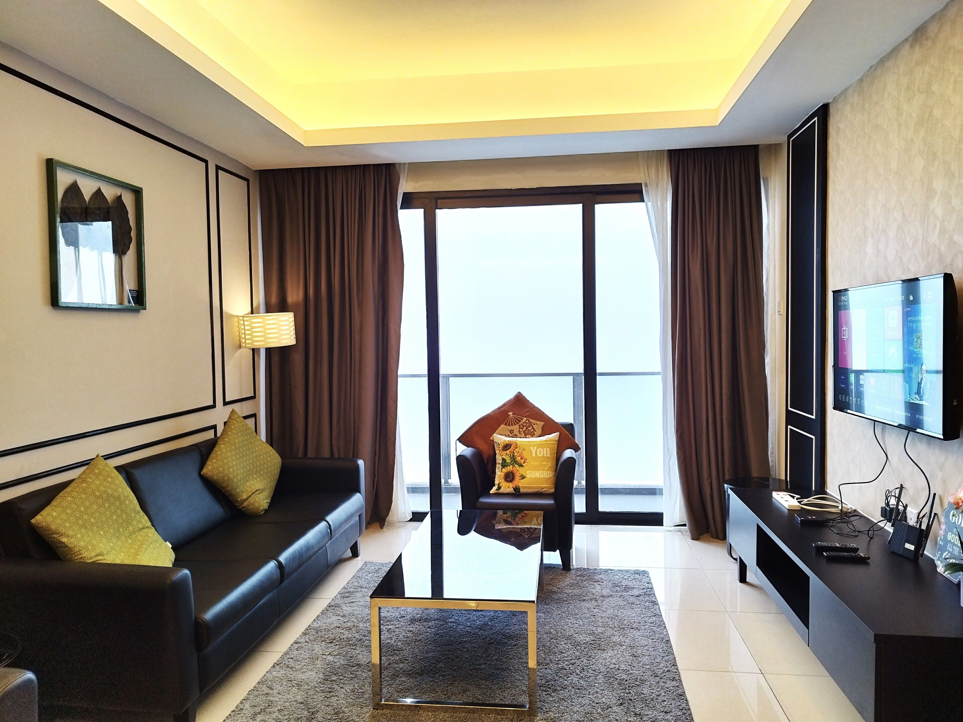Signature Apartment | Living area | 50-inch flat-screen TV with cable channels