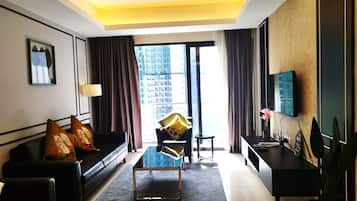Signature Apartment | Living area | 50-inch flat-screen TV with cable channels
