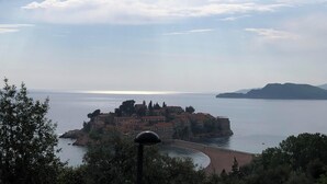 A coastal town with a prominent castle-like structure surrounded by water.