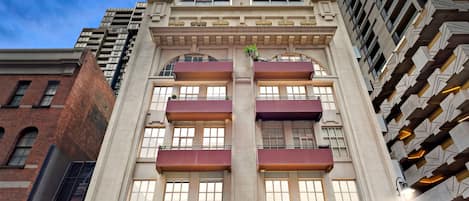 A multi-story building with a central courtyard, large windows, and a modern architectural design.