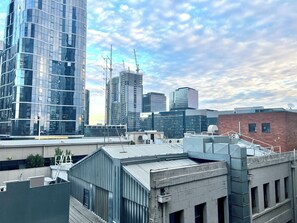 A modern urban skyline with high-rise buildings, construction cranes, and a mix of commercial and residential structures. - Readyset Apartments on Little Bourke (Melbourne)