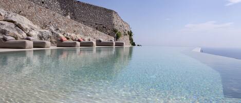 Seasonal outdoor pool, open 10:30 AM to 8:00 PM, pool umbrellas