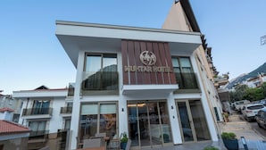 A modern hotel building with a prominent sign reading "MIGHTAR HOTEL". - Muhtar Hotel (Kas)