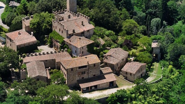 A medieval-style village with stone buildings and a central tower.