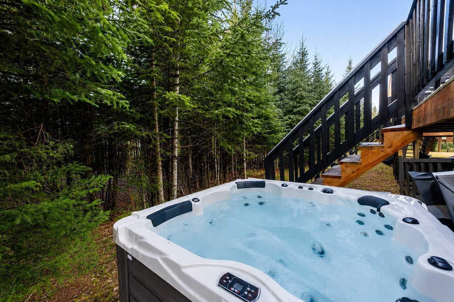 A hot tub surrounded by a wooden deck and dense forest.