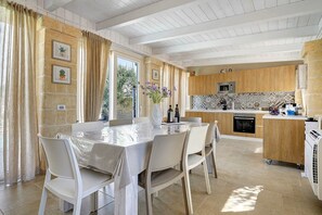 A modern kitchen with wooden cabinets, a built-in oven, and a microwave.