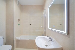 A modern bathroom with a glass-enclosed shower, a white sink, and a large mirror. - iloftmalaga Carreteria 77 - II (Malaga)