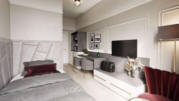 A modern bedroom with a large bed, a desk, and a TV.