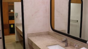 A bathroom with a marble countertop, a sink, a mirror, and a shower area. - Viva Azteca by Wyndham, A Trademark All Inclusive Resort (PLAYA DEL CARMEN)