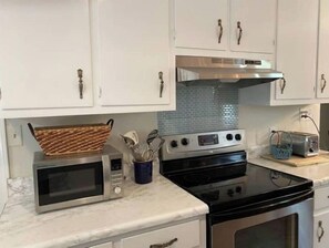 Enjoy cooking in this well-equipped kitchen with a microwave, stove, and toaster.