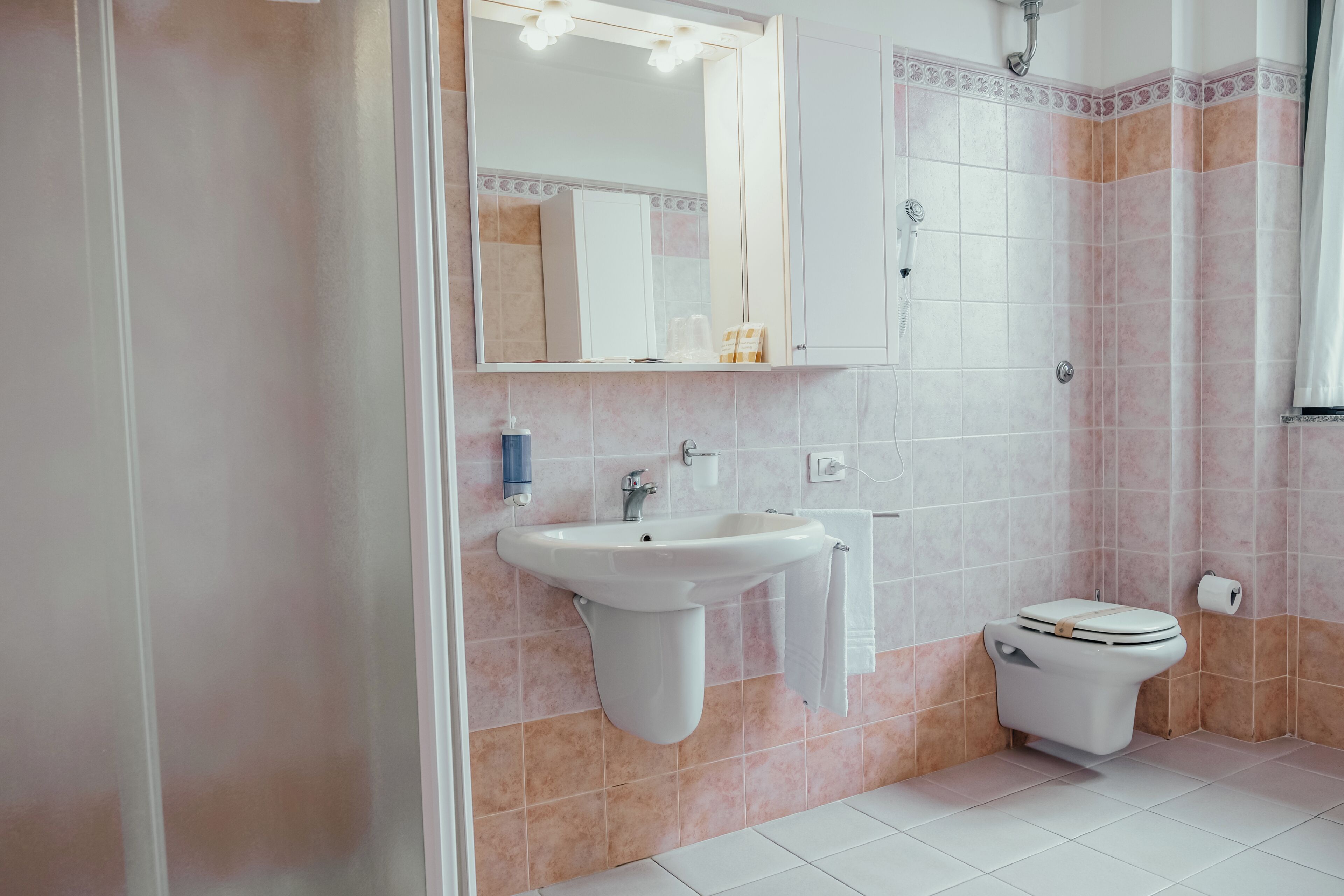 A bathroom with a sink, toilet, and shower.