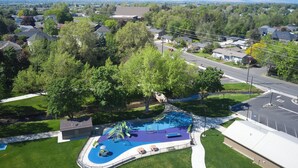 An aerial view of a residential area with a playground, a road, and houses. - ESCAPE TO WALLA WALLA WINE COUNTRY — YOUR PRIVATE KING SUITE ACROSS FROM TH... (College Place)
