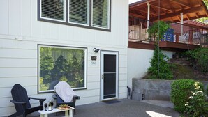 A house with a porch, a black chair, a table with a bottle and glasses, and a door with the number 968. - ESCAPE TO WALLA WALLA WINE COUNTRY — YOUR PRIVATE KING SUITE ACROSS FROM TH... (College Place)