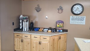 A kitchenette with a coffee machine, a clock, and a sign prohibiting smoking. - The B&B Motel (Lewistown)