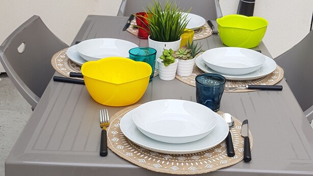A table set for four with plates, bowls, and cutlery. - Beautiful renovated house (Mirano)